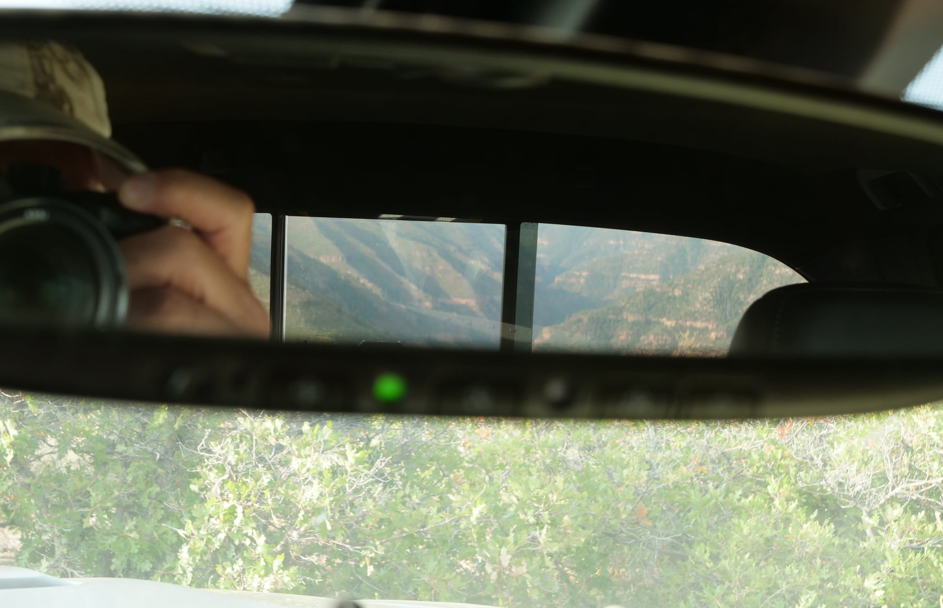 Dave Lalande overlanding — a red-rock canyon reflected in the rearview mirror